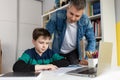 Father helping son finish homework