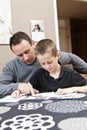 Father helping son with homework Royalty Free Stock Photo