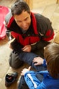 Father Helping Son To Put On Warm Outdoor Boots Royalty Free Stock Photo