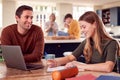 Father Helping Teenage Daughter With Homework Sitting At Kitchen Table At Home Using Laptop Royalty Free Stock Photo