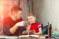 The father helps his son to do homework for the school Royalty Free Stock Photo