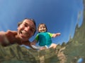 Underwater view of a father and her daughter with distorted face Royalty Free Stock Photo