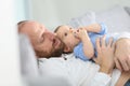 Father and his baby boy relaxing on a sofa Royalty Free Stock Photo