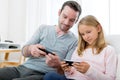 Father and his blond daughter using mobile Royalty Free Stock Photo