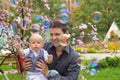 Father and his child playing with soap bubbles Royalty Free Stock Photo