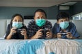 Father and his children playing video game on bed Royalty Free Stock Photo