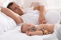 Father with his cute baby sleeping in bed at home Royalty Free Stock Photo