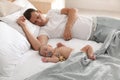 Father with his cute baby sleeping in bed at home Royalty Free Stock Photo