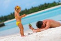 Father and his daughter have a fun on exotic beach