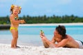 Father and his daughter have a fun on exotic beach