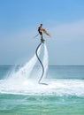 Father and his daughter posing at new flyboard at Caribbean tropical beach