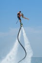 Father and his daughter posing at new flyboard at Caribbean tropical beach. Positive human emotions, feelings, joy. Funny cute chi