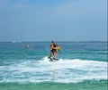 Father and his daughter posing at new flyboard at Caribbean tropical beach. Positive human emotions, feelings, joy. Funny cute chi