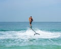 Father and his daughter posing at new flyboard at Caribbean tropical beach. Positive human emotions, feelings, joy. Funny cute chi