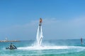 Father and his daughter posing at new flyboard at Caribbean tropical beach. Positive human emotions, feelings, joy. Funny cute chi