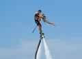 Father and his daughter posing at new flyboard at Caribbean tropical beach. Positive human emotions, feelings, joy. Funny cute chi