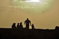 Father and his five children at sunset