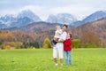 Father with his kids in mountain covered snow