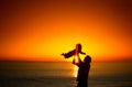 Father and his little baby son play on sunset beach. Family vacation on the sea. Royalty Free Stock Photo