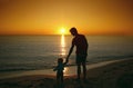 Father and his little baby son stay together on sunset beach. Fa Royalty Free Stock Photo