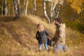 Father and his little daughter together in the forest.