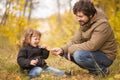 Father and his little daughter together in the forest.