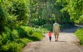 Father and his little daughther walking hand in hand together on