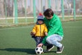 Father with his little son having fun, playing football, soccer in the park Royalty Free Stock Photo
