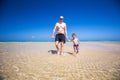 Father and his little son having fun and running on the beach. Royalty Free Stock Photo