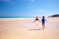 Father and his little son having fun and running on the beach. Royalty Free Stock Photo