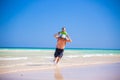 Father and his little son having fun and running on the beach. Royalty Free Stock Photo