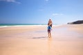 Father and his little son having fun and running on the beach. Royalty Free Stock Photo