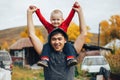 Father and his little son playing outdoors. Little boy sitting on the shoulders of his father. Royalty Free Stock Photo