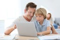 Father and his little son using laptop Royalty Free Stock Photo