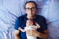 Father with his newborn baby son lying in bed Royalty Free Stock Photo