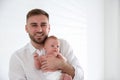 Father with his newborn son on background. Space for text Royalty Free Stock Photo