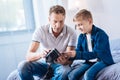 Father and his pre-teen son examining new VR headset