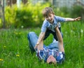 Father with his small son playing in the grass on the summer. Royalty Free Stock Photo