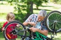 Father and his son fixing a bike