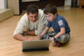 Father and his son with laptop