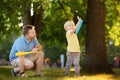 Father and his son playing baseball in park. Royalty Free Stock Photo
