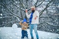 Father and his son playing outdoors. Cute little child boy and happy father on snowy field outdoor. Winter family in Royalty Free Stock Photo