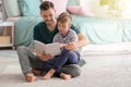 Father and his son reading book together at home Royalty Free Stock Photo
