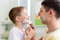 Father and his son shaving and having fun in Royalty Free Stock Photo