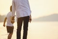 Father and his son who enjoy a picnic and sea bathing at the beach on sunset in holiday. Royalty Free Stock Photo