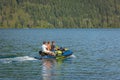 Father with his sons having fun jumping a wave riding jet ski on a Cultus Lake British Columbia Royalty Free Stock Photo