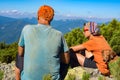 Father and his teenage son with funny dog in mountains Royalty Free Stock Photo