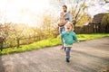 A father with his toddler children outside on a spring walk. Royalty Free Stock Photo