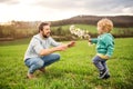 A father with his toddler son outside in spring nature. Royalty Free Stock Photo