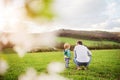 A father with his toddler son outside in spring nature. Royalty Free Stock Photo